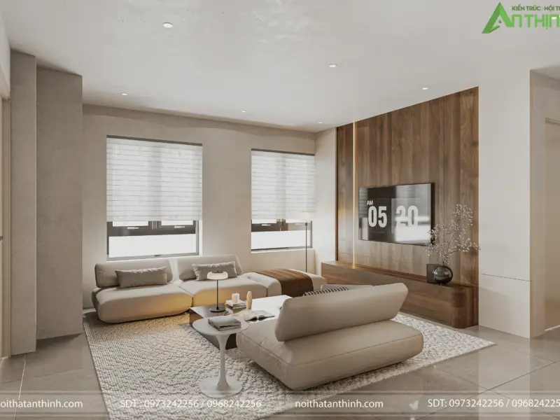 Góc nhìn thứ hai phòng khách – bộ sofa trắng bo cong hữu cơ, bàn cà phê tròn nhỏ, vách gỗ óc chó làm nền tivi tạo chiều sâu