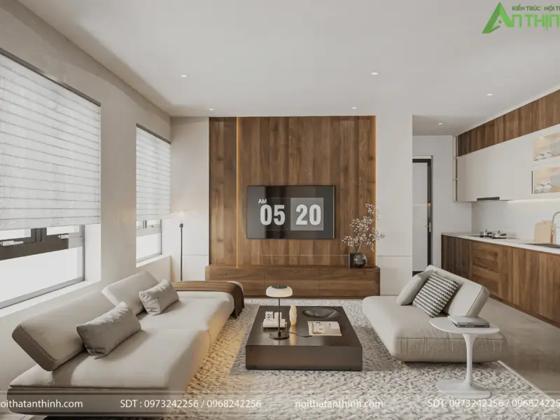Toàn cảnh phòng khách – bếp liên thông từ góc rộng nhất, thấy đầy đủ sofa trắng, vách tivi gỗ nâu ấm và khu bếp mở phía sau