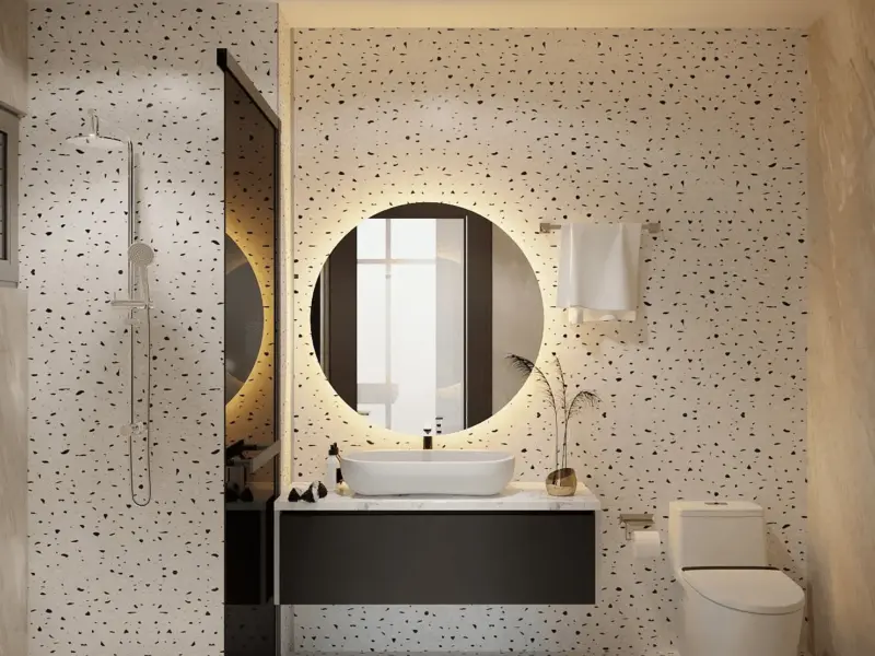 WC con trai – terrazzo đen trắng mạnh mẽ, gương tròn LED viền đen, bàn lavabo đen tương phản, vòi sen kính
